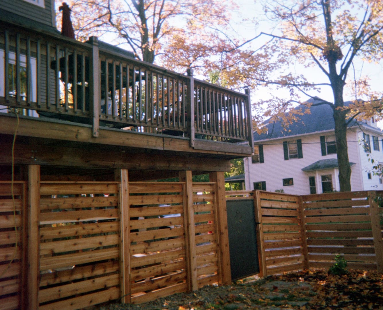 Wooden deck and fence in backyard