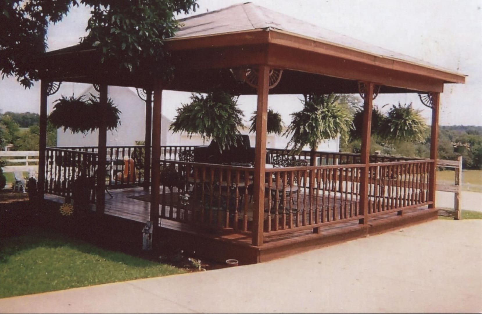 Wooden gazebo with hanging plants
