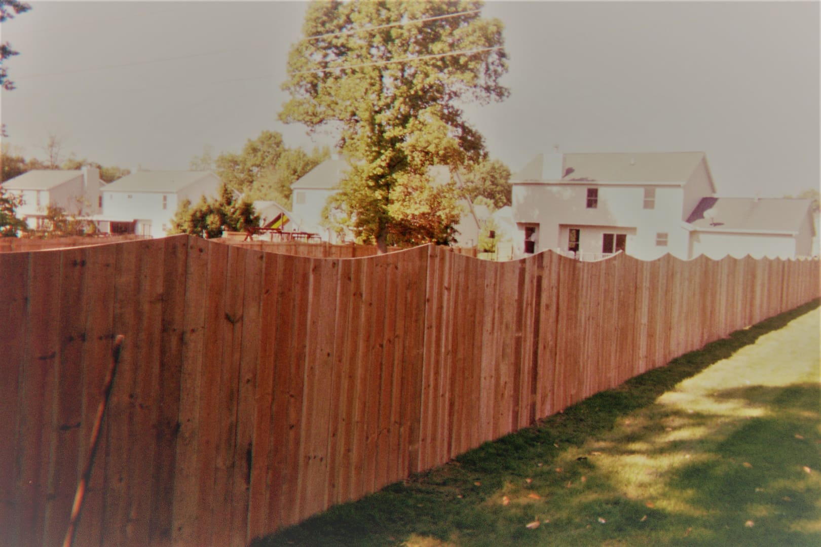 Residential area with tall wooden fence