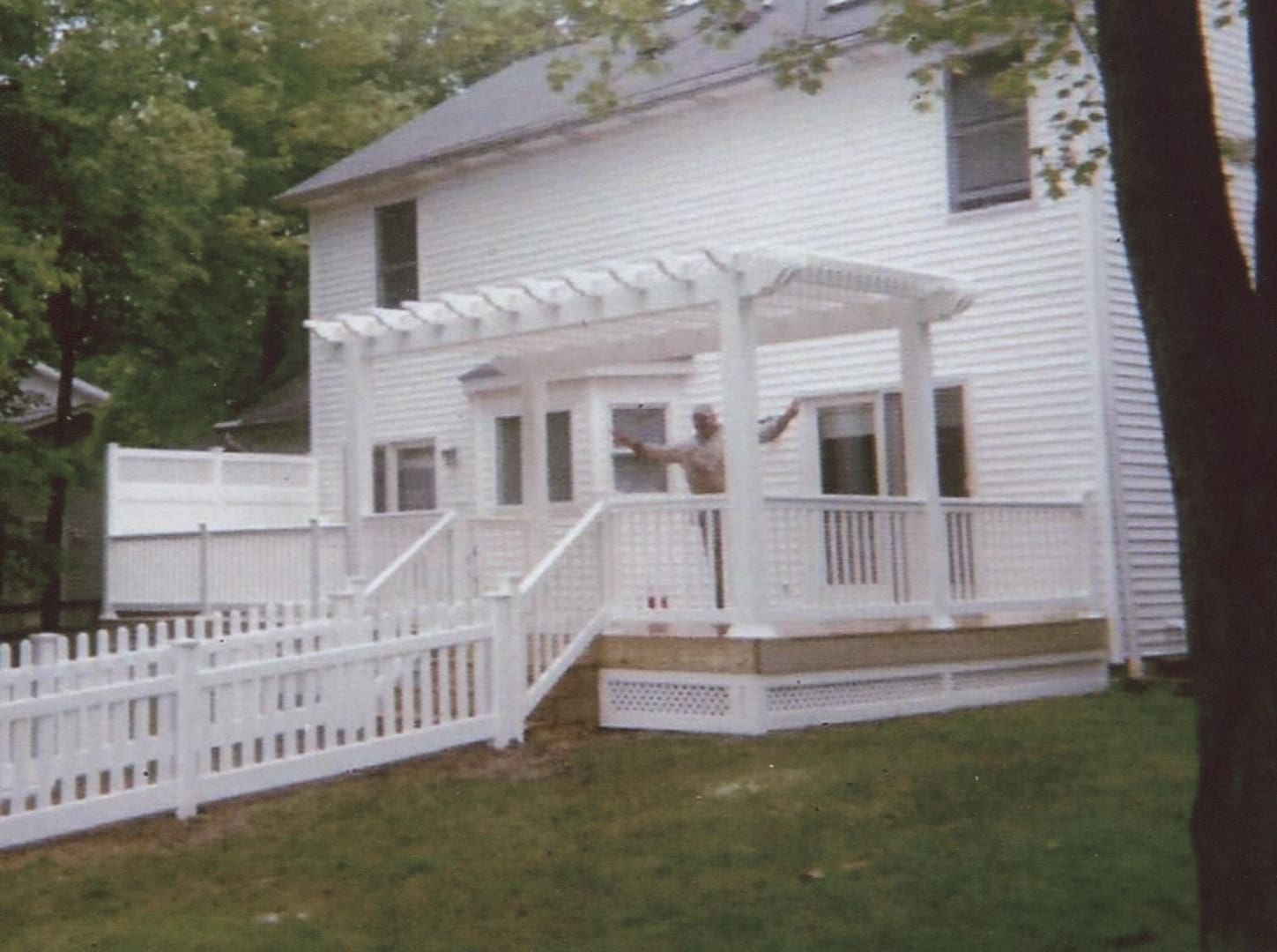 Backyard with white fence and pergola