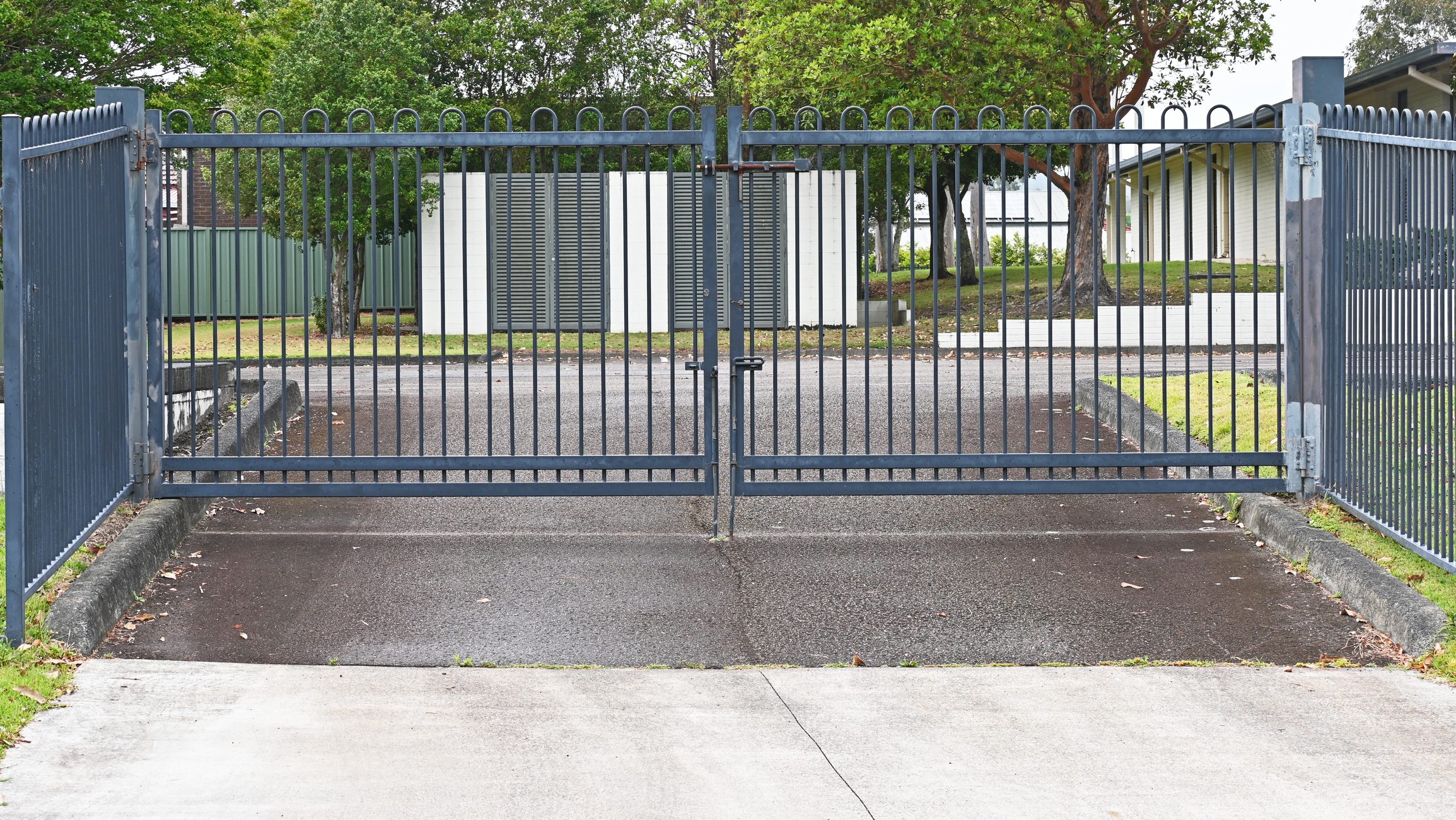Metal entrance gate across a driveway